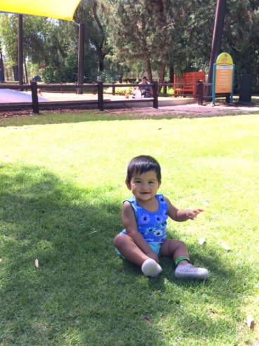 Enjoying and exploring the green green grass in Perth at 10 months old